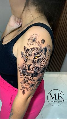 a woman with a leopard tattoo on her arm