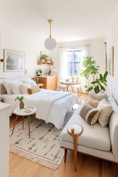 a bedroom with a bed, couch and coffee table in the corner next to a window