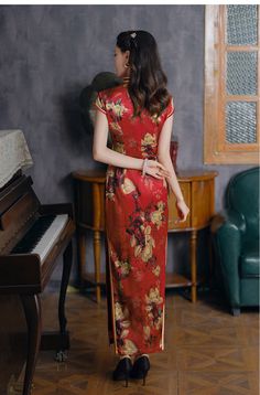 This striking Qipao aka Cheongsam is made from luxurious red silk, featuring intricate magnolia flower, mandarin collar and cap sleevee The red base, symbolic of joy and celebration, is complemented by delicate gold piping along the edges. Adorned with traditional knot buttons, this Qipao is ideal for weddings, banquets, or festive occasions, blending timeless Chinese fashion with modern refinement. Material: 90% Mulberry Silk, 10% Spandex Size Guide: Please note Asian size runs small, please ch Red Elegant Cheongsam For Spring, Elegant Red Cheongsam For Spring, Traditional Red Cheongsam For Formal Occasions, Red Fitted Cheongsam For Festive Occasions, Red Spring Wedding Cheongsam, Fitted Red Cheongsam For Festive Occasions, Festive Red Fitted Cheongsam, Festive Fitted Red Cheongsam, Red Cheongsam For Spring Festivals