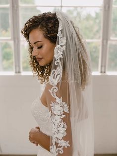 a woman in a wedding dress and veil