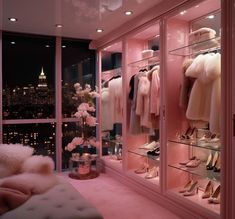 a bedroom with pink walls and lots of clothes on display in the window sill