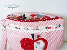 a red and white checkered bag with an apple on it