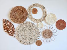 several woven baskets are arranged next to each other on a white surface with brown accents