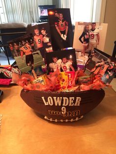 a bowl filled with pictures and candies on top of a table