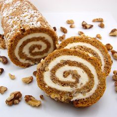 there is a roll that has been cut in half and some nuts on the side