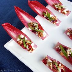 small appetizers are arranged on a white plate