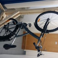 there is a bike hanging from the ceiling