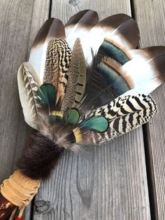 a feather headdress with feathers attached to it on top of a wooden table