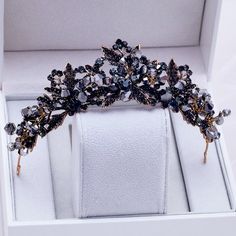 Inspired by the old days of royalty when times were filled with extravagant parties and lavish luxuries, this unique tiara conveys a modern take on old elegance and grand entrances. Adorned with black rhinestones and intricately faceted Swarovski crystals that work their way across the band in a swirly pattern, this is a hair accessory that can complete the most sophisticated of gothic bridal looks. Cast in lightweight bronze alloy, the tiara measures 1.75" at the tallest point (approx. 4.5cm) a Veil Tiara, Black Tiara, Crown Aesthetic, Bridal Tiaras, Wedding Hair Headband, Beautiful Tiaras, Gold Tiara, Black Bridal, Headband Tiara