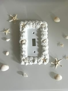 a light switch cover with sea shells around it