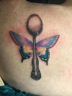 a woman's back with a spoon and butterfly tattoo on it