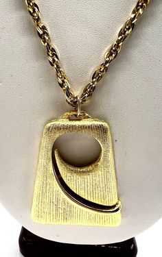 Fabulous gold tone 2 1/4 inch pendant necklace featuring a modernist pendant.  Set in gold tone metal, this necklace would be perfect as an addition to your wardrobe.   JJ signed jewelry started operation in 1943 in Providence, Rhode Island. No longer being made today, the JJ signature was replaced in 1986 by Artifacts.  Collect Jonette Jewelry  while they are still available.  Size: Pendant - 1 3/4 inches wide by 2 1/4 inches tall           Chain - 18 inch drop  Condition: vintage very good -    For other gorgeous vintage jewelry, please visit my shop at https://www.etsy.com/shop/VintagObsessions Luxury Gold Modernist Necklace, Luxury Modernist Gold Necklace, Providence Rhode Island, Gold Box, Pendant Set, Surprise Gifts, Designer Jewelry, Rhode Island, Gold Style