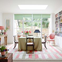 a living room filled with furniture and lots of books