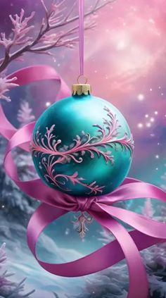 a blue christmas ornament hanging from a tree with pink ribbon and snowflakes in the background