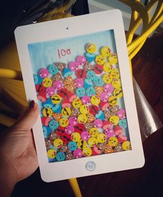 a person holding up an ipad with buttons on it