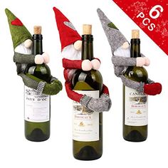 three wine bottles with gnomes on them and one has a red ribbon around its neck