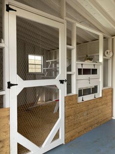 the inside of a building with white doors and wood paneling on the outside wall