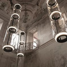 a chandelier hanging from the ceiling in an old building