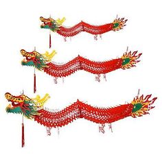 three red and green dragon kites flying in the air with long tails on each side