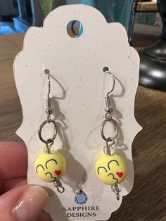 Get ready to add a pop of color to your wardrobe with our adorable emoji dangle earrings! These fun and quirky earrings are the perfect way to show off your playful personality and make a bold fashion statement. Handmade with care, each pair features a yellow emoji, creating a fun and unique accessory that is sure to turn heads. Whether you're heading to a festival, party, or just want to add a touch of excitement to your everyday look, these earrings are a must-have. Lightweight and comfortable to wear, these emoji dangle earrings are perfect for all-day wear.  Stand out from the crowd and express your individuality with these fun and stylish emoji dangle earrings. Order yours today and let your personality shine through with every wear! Adorable Emoji, Yellow Emoji, Quirky Earrings, Etsy Earrings Dangle, Festival Party, Bold Fashion, Accessories Unique, Jewelry Earrings Studs, Everyday Look