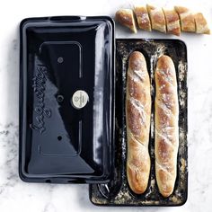 some bread is sitting on a baking pan and next to it's cutters