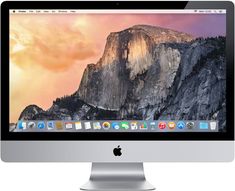 an apple desktop computer with the mountain in the background