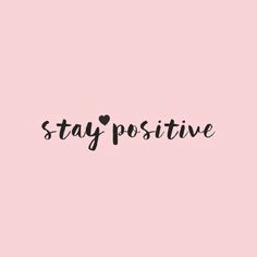 the words stay positive are written in black ink on a pink background with a heart