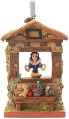 snow white and the seven dwarfs figurine on display in an ornament