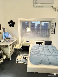 a bed room with a neatly made bed and a desk in front of a window