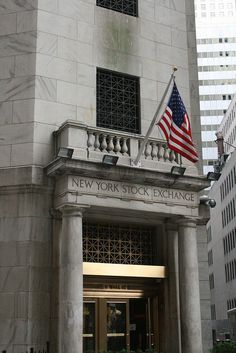 the new york stock exchange building has an american flag on it's front door