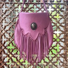 Our most popular bag can be customized with either a Clear Quartz Crystal or a Concho for the centerpiece. Comes in a variety of colors.  Premium cowhide leather bag hand-stitched with fringe detailing on the flap. Hand-braided leather strap with tassel ends. Small inside pocket. This bag is unlined.  Measures 11" W x 10.5" H. 45" strap.  Made to order.   I will gladly ship internationally. Please message for rates. Thanks for looking! Traditional Fringe Bag For Everyday Use, Brown Bohemian Satchel With Fringe, Artisan Leather Shoulder Bag With Fringe, Leather Fringe Pouch Bag, Fringe Satchel Shoulder Bag, Western Leather Bag With Fringe, Brown Bohemian Fringe Satchel, Bohemian Leather Fringe Satchel, Fringe Tote Bag