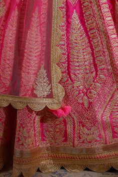 Editor's Note Gota Embroidered Raw Silk Lehenga With Embroidered Net Dupatta Color: Coral Pink Fabric: Raw Silk And Net Embroidery Details: Gota Embroidery Care: Dry Clean Only About the Designer Shyam Narayan Prasad started his journey in the Indian Fashion Design Industry with a couture women’s wear collection. The designer has a womenswear label focussing on Indian ethnic wear which ranges from bridal lehengas, saris, and festive kurtas to casual tunics. Gota Embroidery, Blouse Yoke, Net Embroidery, Raw Silk Lehenga, Dress Book, Embroidered Lehenga, Bridal Lehengas, Casual Tunics, Stylish Dress Book