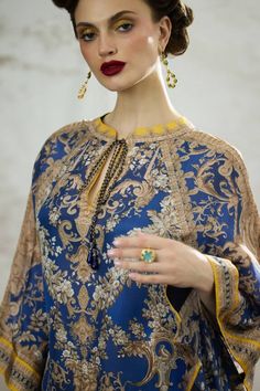 Blue silk poncho top with all over regal floral prints. - Aza Fashions Elegant Long Sleeve Printed Kaftan, Elegant Floral Print Festive Kaftan, Elegant Silk Kurta With Digital Print, Elegant Blouse With Printed Motifs, Elegant Multicolor Tunic Kurta, Elegant Blue Floral Print Kurta, Elegant Kaftan With Printed Motifs And Kimono Sleeves, Elegant Festive Kaftan With Printed Motifs, Elegant Festive Blouse With Printed Motifs