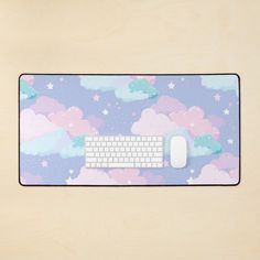 a mouse pad with a keyboard and clouds on it