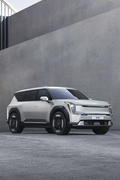 an electric vehicle parked in front of a concrete wall