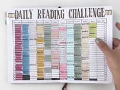 someone holding up a daily reading challenge book