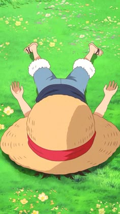 a person laying on top of a grass covered field with their hands in the air