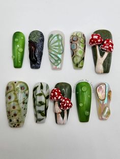 These magical nails feature a mix of 10 different fairycore/forest themed designs. Designs include: 3D dew drops on abstract leaf, 3D slug on rock w/moss, textured butterfly wing with glitter topper over a iridescent chrome base, abstract design in earth tones, 3D amanita mushrooms, abstract design in earth tones, 3D amanita mushrooms, 3D dew drops on abstract leaf & rainbow shell pieces over a chrome base. Includes: 10 hand painted, press on nails and a nail prep kit (tube of nail glue, cuticle Mushrooms Nails Design, Goth Mushroom Nails, 3d Leaf Nails, Moss Nail Art, 3d Mushroom Nails, Textures Nails, Green Mushroom Nails, Forest Fairy Nails, Green Flowers Nails