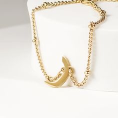 This exquisite bracelet features a delicate satellite chain adorned with a personalized Arabic letter charm. The bracelet's chain has tiny, evenly spaced beads adding a touch of sparkle and elegance. The focal point of this stunning piece is the Arabic letter charm, meticulously designed and crafted to capture the beauty and intricacy of the letter. Perfect for everyday wear or special occasions, this bracelet makes a meaningful and stylish statement, whether worn alone or layered with other pie Minimalist Satellite Chain Bracelet As Gift, Minimalist Satellite Chain Bracelet Gift, Minimalist Bracelet With Moon Charm As Gift, Elegant Adjustable Bracelet With Moon Charm, Minimalist Bracelets With Moon Charm As Gift, Elegant Personalized Metal Beaded Bracelets, Elegant Stainless Steel Jewelry With Moon Charm, Yellow Gold Bracelet With Moon Charm As Gift, Elegant Everyday Bracelets With Moon Charm