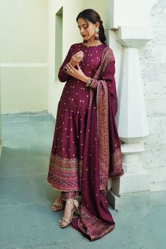 Burgundy maroon long anarkali with woven floral motifs scattered all-over and a thick border on the hem and sleeve hems. Comes with co-ordinating straight pant with a border on the hem and woven motifs dupatta.
Component: 3
Pattern: Woven
Type Of Work: Floral Motifs
Neckline: Round
Sleeve Type: Full
Fabric: Vegan Silk; Lining: Shantoon
Color: Maroon
Other Details: 
Dupatta with scattered floral woven motifs and thick border
Scallop trim on the hem
Show button detail on the concealed front placke Long Anarkali, Scallop Trim, Cute Winter Outfits, Love Clothing, Floral Motifs, Affordable Clothes, Straight Pants, College Outfits, Set For Women