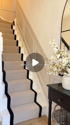 a vase filled with flowers sitting on top of a stair case