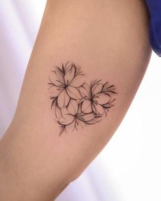 a black and white photo of a flower tattoo on the right thigh, with small flowers in the center