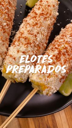 some food is on a black plate with toothpicks in it and the words elotes preparados