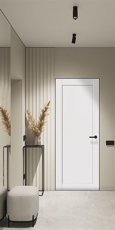 an empty room with a white door and two stools in front of the door