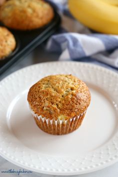 a muffin on a white plate with the words best ever banana muffins