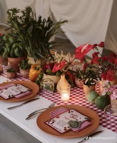 the table is set with flowers and place settings