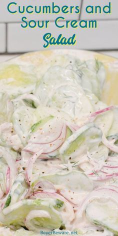 cucumbers and sour cream salad in a yellow bowl on a white countertop