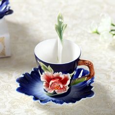 a coffee cup with a flower painted on it