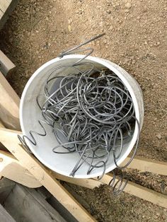 a bucket filled with lots of metal wire