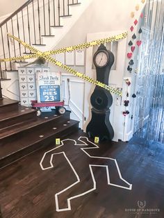 there is a clock on the floor next to some stairs with caution tape around it